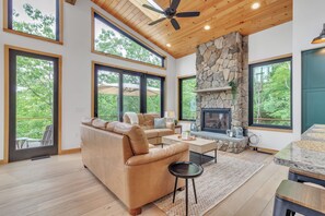 Living room with gas fireplace and access to deck