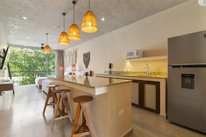 Granite island with bar stools and views—great for dining or work.