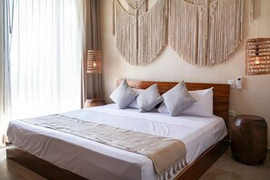 Stylish master bedroom with cozy bed, macramé art, and warm lighting.