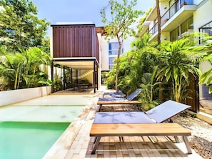 Shared pool with loungers—ideal for sun, swims, and Tulum memories.