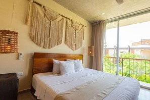 Bedroom opens to a private patio with blackout shades for privacy.