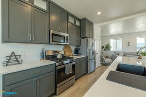 Open layout with sleek amenities encourages culinary creativity, socializing, and savoring delicious moments in style. Prepare, gather, and relish in this inviting space designed for both functionality and aesthetics.