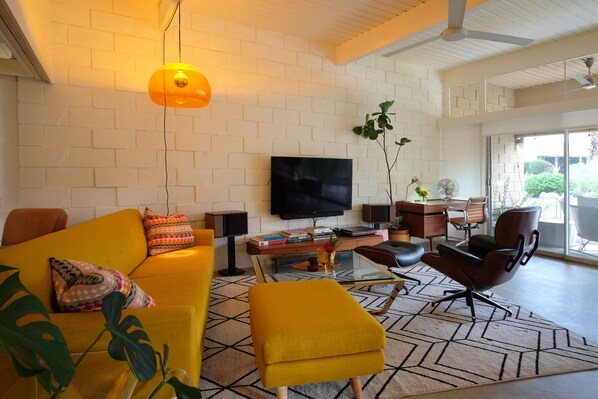 Open living room with comfy seating, TV, views or full privacy with blinds.