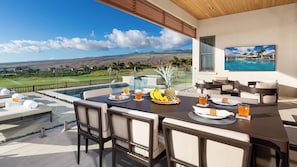 Lanai with outdoor dining and living area. 85" Extra Large TV. Glass railings for kid safety!