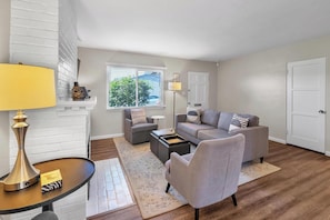 Living room: sofa, two chairs, TV