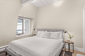 The master bedroom features a king bed, flat screen TV and en suite bathroom.