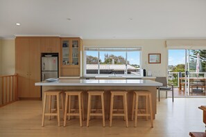 Spacious kitchen area with large island bench and a favourite gathering area 

