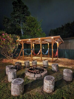 Enjoy a bonfire and the well lit hammock station at night! 