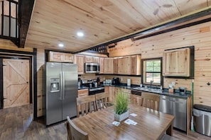 Open kitchen with stainless steel appliances.