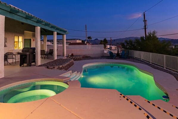 Enjoy a serene evening by the lit pool.