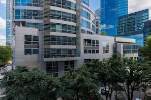 Exterior view of the apartment building surrounded by greenery and modern architecture.