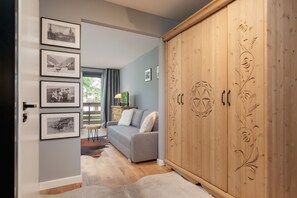 Bedroom with a carved wooden wardrobe, adding a rustic and charming touch.

