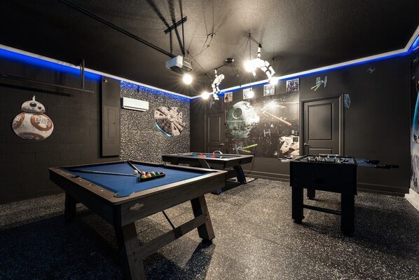 Immerse yourself in this themed game room with pool, air hockey, and foosball, perfect for fun-filled evenings.