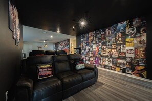 Experience cinematic magic in this cozy home theater with plush seating and iconic movie decor.