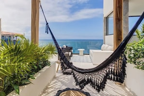 Relax on the rooftop hammocks and feel the ocean breeze