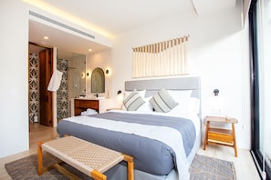 The bedroom features a comfortable king-size bed with an ensuite bathroom