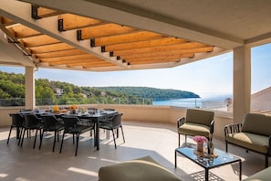 30.	Private balcony of Croatia luxury pool villa with sea view and seating area for vacation and rent