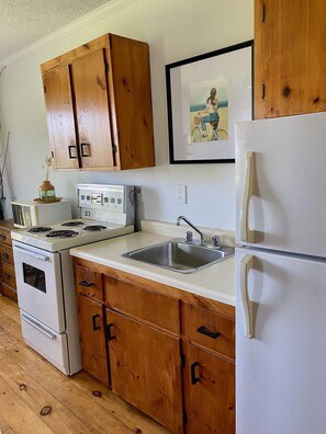 Well stocked kitchen with dishes, pots and pans, BBQ utensils etc.