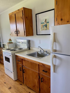 Well stocked kitchen with dishes, pots and pans, BBQ utensils etc.