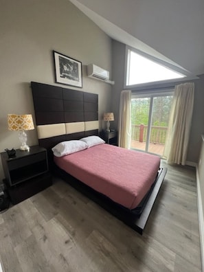 Master suite with queen bed and private bathroom.