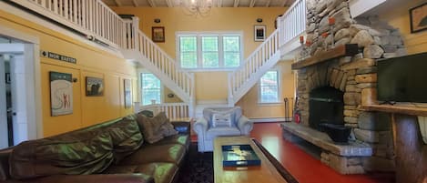 The main level living room with fireplace. It is wood burning and wood is provided.