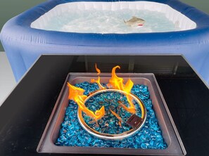 Lounge aside a gas flame firepit.