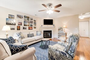 In the Roomy Living Area, the Photo Gallery Wall draws you in. Comfortable Seating will make this your Favorite Indoor Living Space.