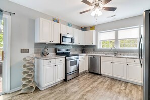 A Designer Wine Rack Compliments the Roomy Kitchen with Lots of Storage & Counter Prep Space.