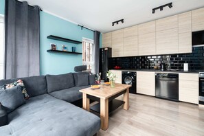 Open-plan living area with a stylish kitchen and comfortable seating for relaxation and dining.

