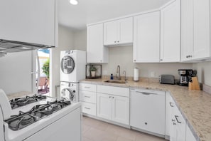 Kitchen: fully stocked with washer and dryer