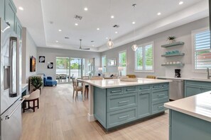 Experience the heart of the home, where the kitchen, dining, and living rooms seamlessly blend to create an inviting and sociable atmosphere