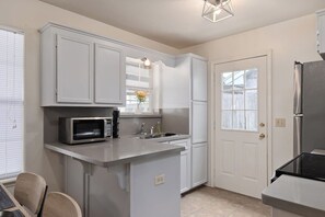 Bright and open fully equipped kitchen where it will be a delight to share meals and moments with family.