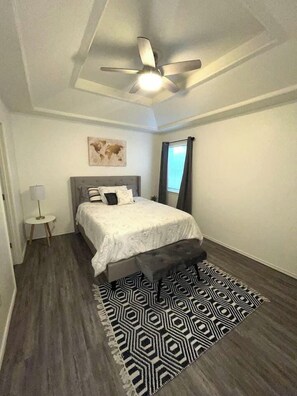 Relax serenely enveloped by the luxurious softness and allure of a queen-sized bed, basking in its warmth and coziness.