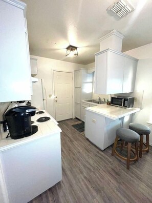 Bright and open fully equipped kitchen where it will be a delight to share meals and moments with family.