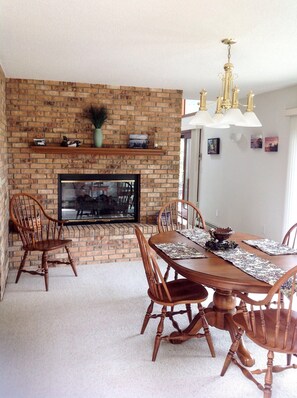 Dining room with lake views and fireplace.