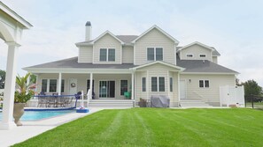 Unwind and soak up the serenity as you overlook the inviting pool from the back of the house.