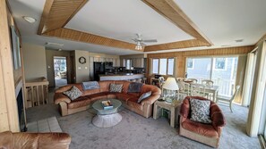 View from great room TV towards seating, dining room, kitchen + beyond in master