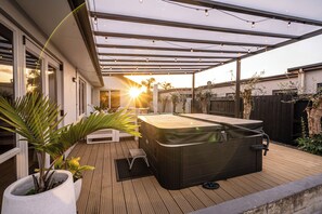Relax in the spa on the covered deck area.