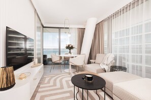 Cozy living area with a neutral-toned sofa, modern coffee table, and large windows for plenty of daylight.




