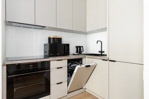 Modern kitchen with sleek cabinets, built-in appliances, and a clean, minimalist design.

