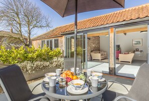 Bromholm Barn, Ridlington: The south-west facing courtyard is the perfect place to while away the evening