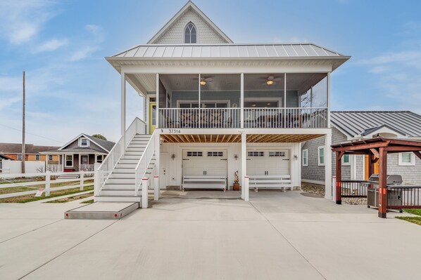 View of the front of house with plenty of parking, gas grill and screened porch