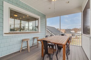 Screened in front porch with outside dining and pass through window