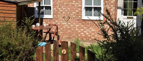 The Owl Box private entrance and garden with a seating area