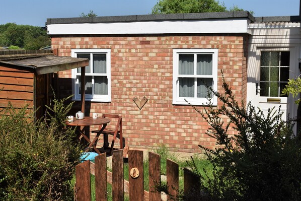 The Owl Box private entrance and garden with a seating area