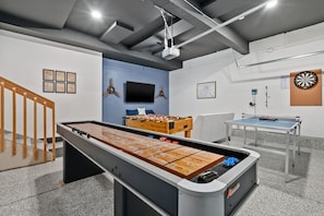 Air Force themed game room in the garage. We've got shuffleboard, ping pong, foosball, darts, boardgames and a 65" smart TV.