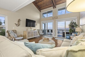 Cozy up on the couch and enjoy the view at this beautiful beach home. 
