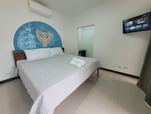 Main bedroom: king sized bed, A/C unit and private bathroom
