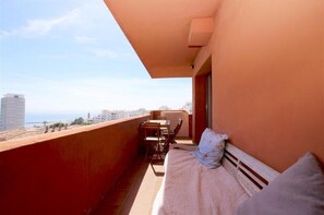 Another picture of the terrace with relaxing seater and dining area for four guests