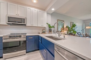 Pristine, modern, completely renovated kitchen, opens to the private golf view!